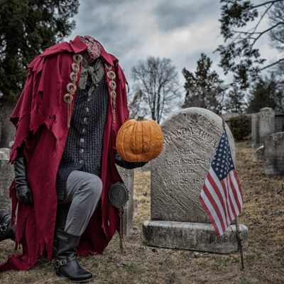 Headless Horseman kneeling at grave of Washington Irving