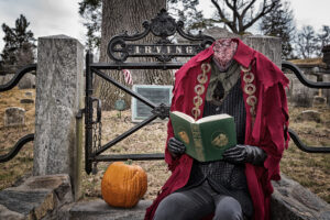 Headless Horseman reading The Legend of Sleepy Hollow at grave of Washington Irving