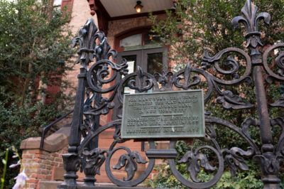 The main entrance to the historical society, showing the ornate iron railing around the property.