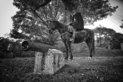The headless horseman stands behind a cannon in Sleepy Hollow Cemetery.