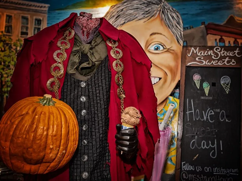 The headless horseman holds a pumpkin and ice cream cone at Main Street Sweets in Tarrytown, NY.