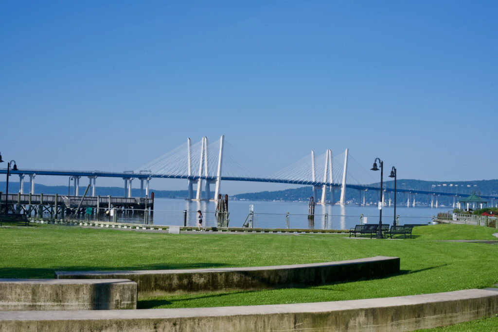 The lawn at Horan's Landing park in Sleepy Hollow, New York, with Mario Cuomo Bridge in background.