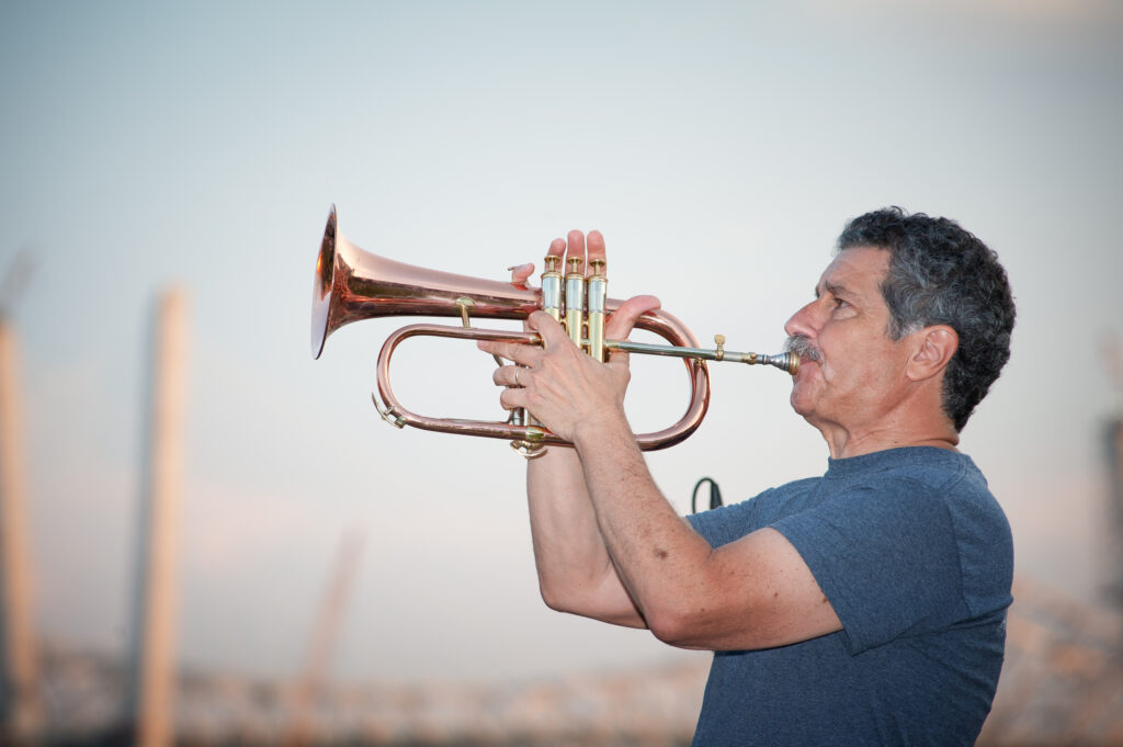 Portrait of jazz musician Mark Morganelli with his flugelhorn.