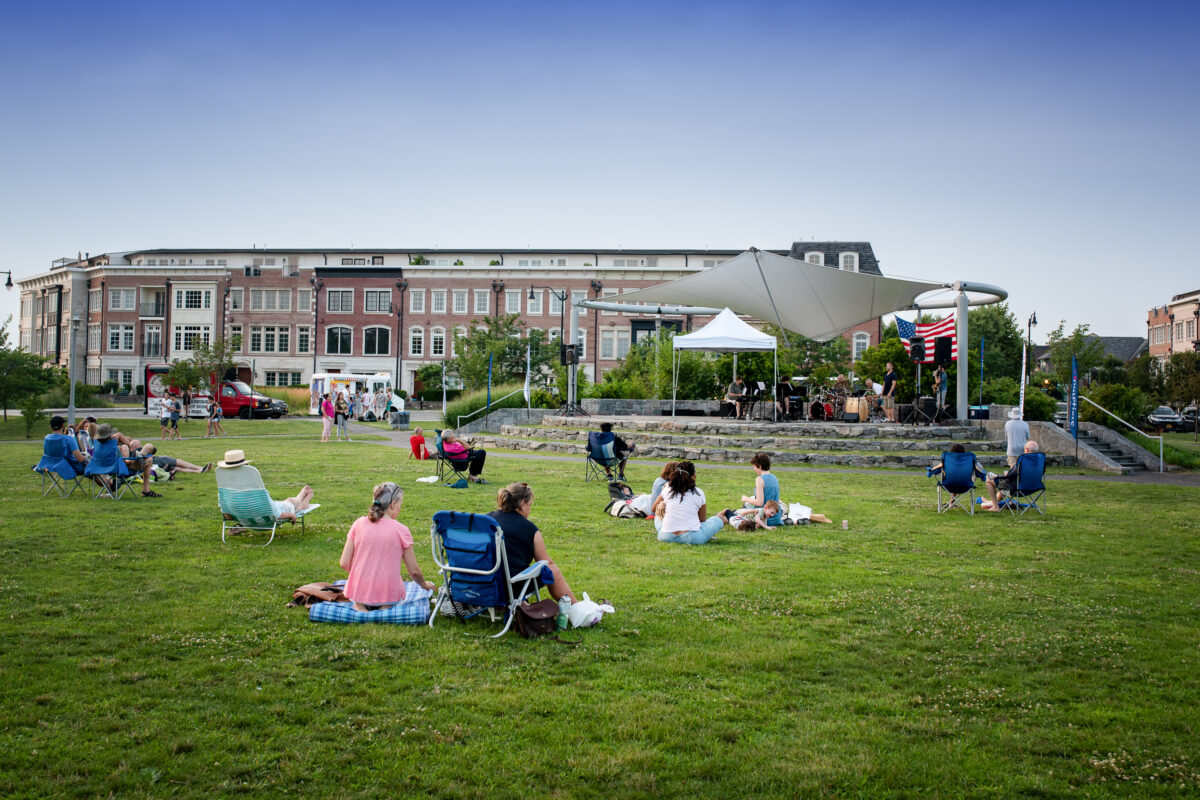 Audience seated on the lawn at Pierson Park in Tarrytown, New York, listening to jazz concert.