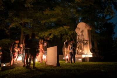 A Sleepy Hollow Cemetery lantern tour pauses at the monument of Henry Villard.