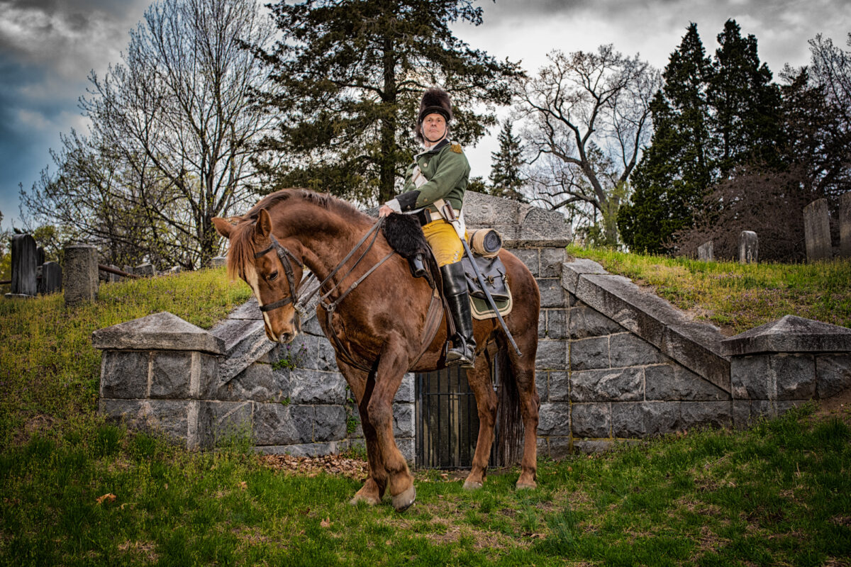 A Revolutionary War reenactor poses near the Hudson River.