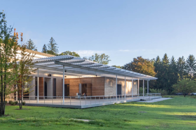 The David Rockefeller Creative Arts Center exterior terrace with surrounding solar panels. Photo by Fred Charles Photography.