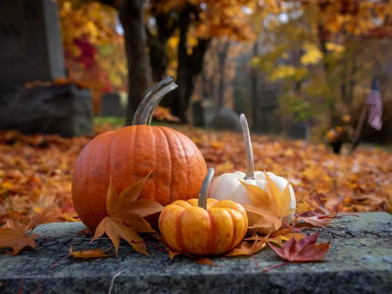 Pumpkins appear on a stone in Sleepy Hollow Cemetery.